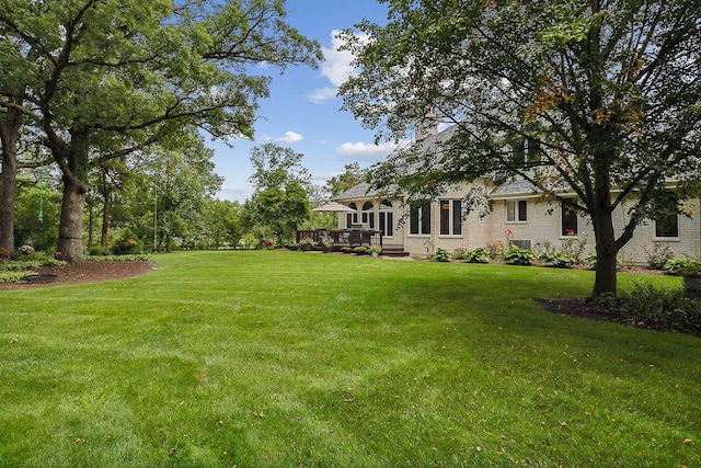 view of yard featuring a wooden deck