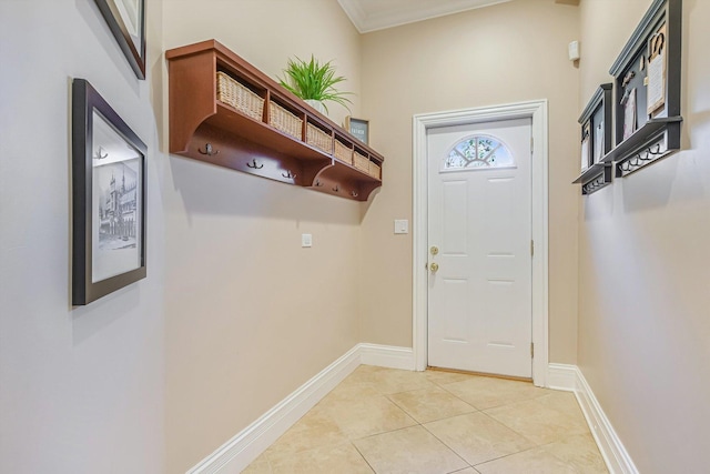 doorway to outside with light tile patterned floors, crown molding, and baseboards