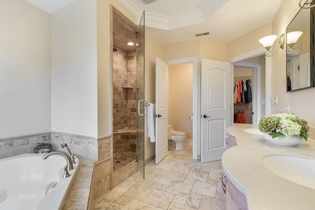 bathroom with visible vents, a shower stall, crown molding, a garden tub, and toilet