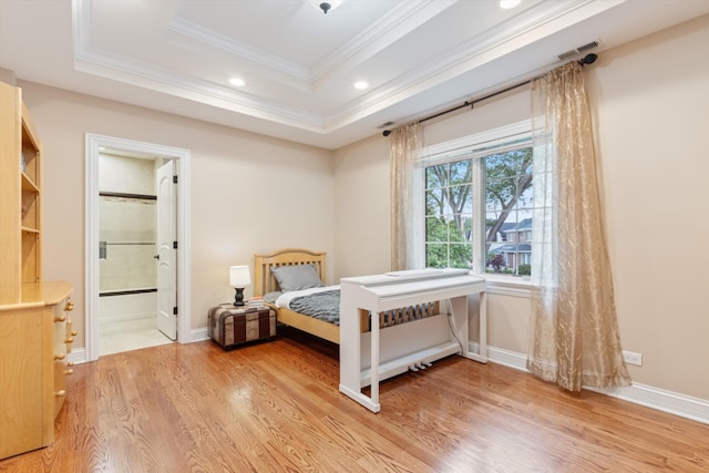 bedroom featuring a tray ceiling, recessed lighting, light wood-style floors, crown molding, and baseboards