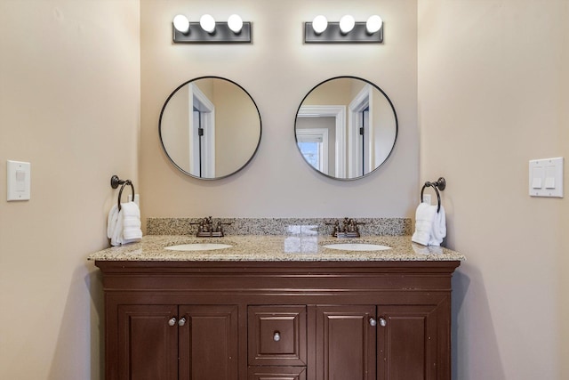 bathroom featuring double vanity and a sink