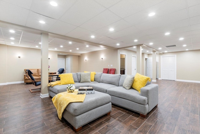 living area featuring visible vents, baseboards, and dark wood-style floors