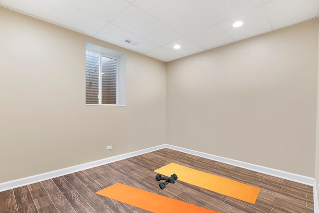 workout area with visible vents, wood finished floors, recessed lighting, baseboards, and a paneled ceiling