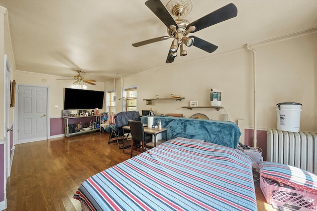 bedroom featuring ceiling fan, hardwood / wood-style flooring, ornamental molding, and radiator