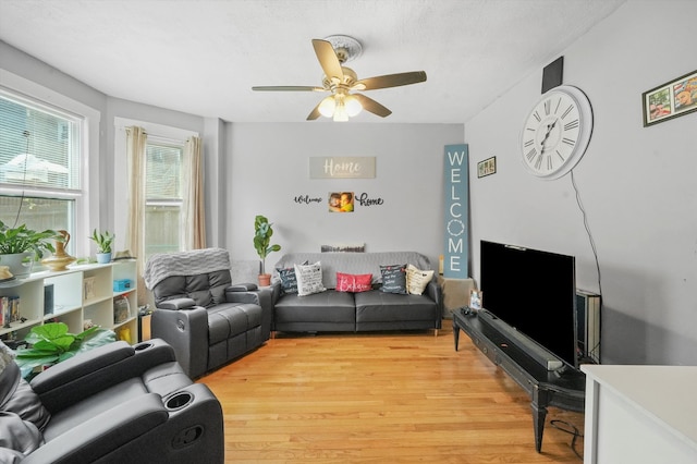 living room with ceiling fan and light hardwood / wood-style flooring