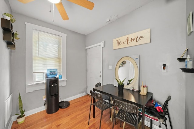 dining space with ceiling fan and hardwood / wood-style floors