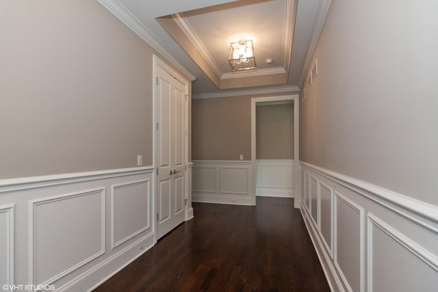 corridor with dark hardwood / wood-style flooring and crown molding