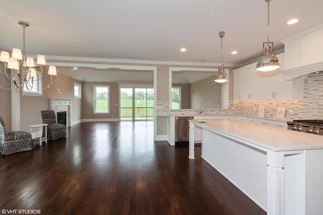 kitchen with stainless steel appliances, tasteful backsplash, dark wood-type flooring, a kitchen island, and white cabinets