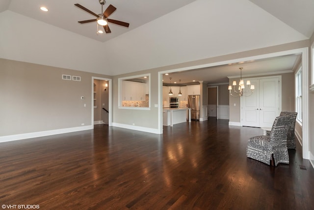 unfurnished living room with lofted ceiling, ceiling fan with notable chandelier, and dark hardwood / wood-style floors