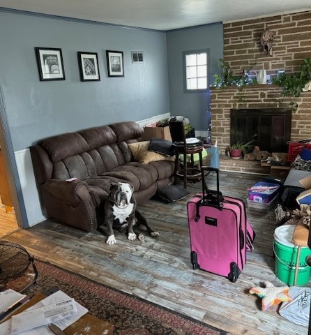 living room with a fireplace and hardwood / wood-style flooring