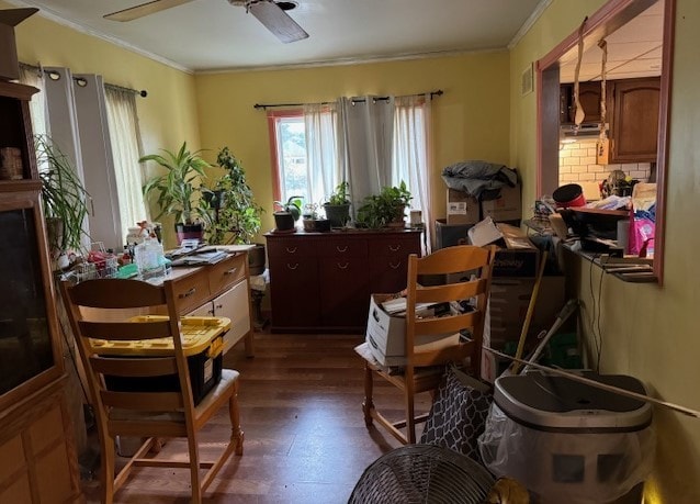 miscellaneous room with ceiling fan, dark wood-type flooring, and ornamental molding