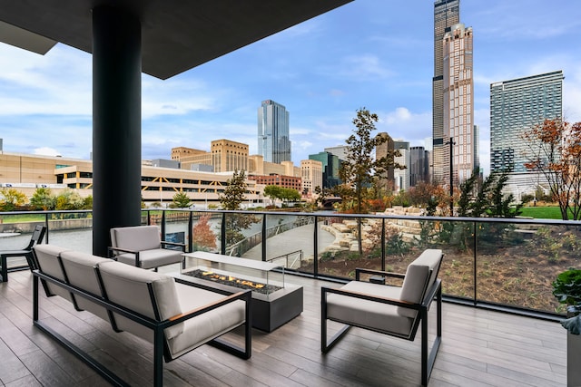 balcony with an outdoor living space with a fire pit