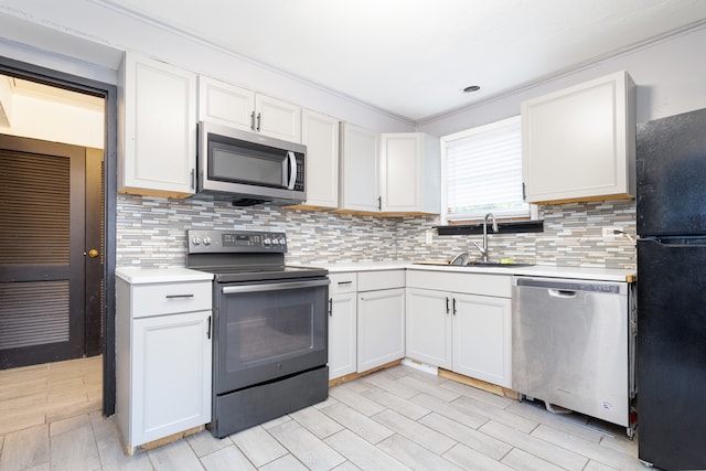 kitchen with white cabinets, black appliances, and backsplash