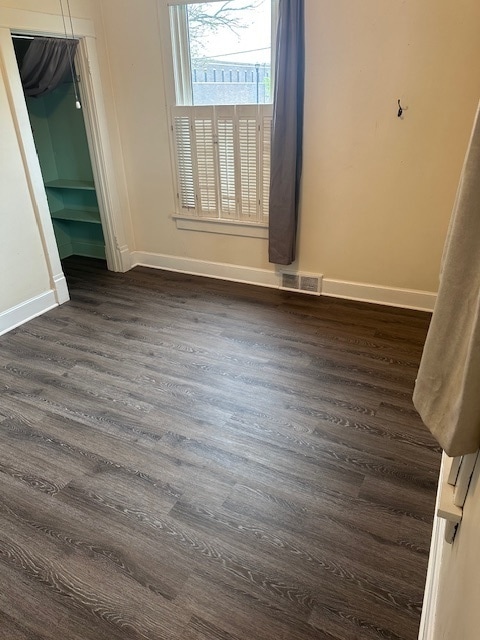 unfurnished room featuring dark hardwood / wood-style floors