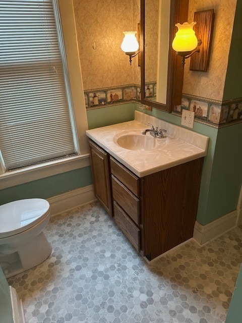 bathroom featuring tile patterned floors, vanity, and toilet