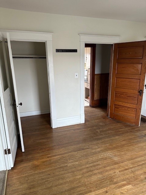 unfurnished bedroom featuring hardwood / wood-style floors and a closet