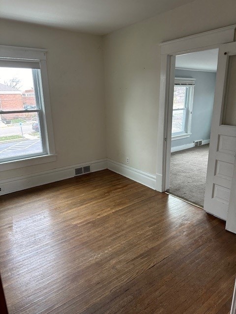 unfurnished room with hardwood / wood-style floors