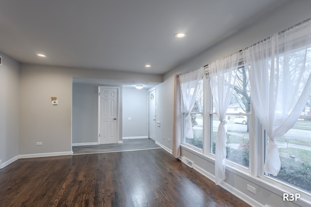 unfurnished room with hardwood / wood-style flooring