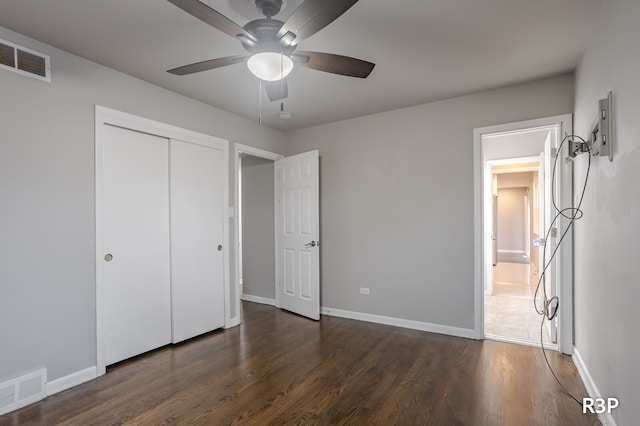 unfurnished bedroom with a closet, ceiling fan, and hardwood / wood-style floors