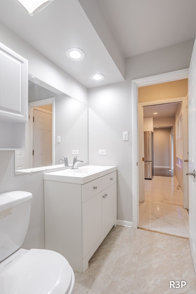 bathroom with tile patterned flooring, toilet, and vanity