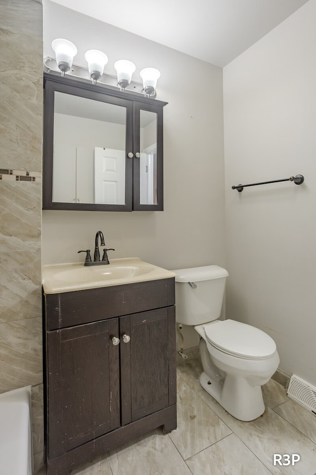 bathroom with tile patterned flooring, toilet, and vanity