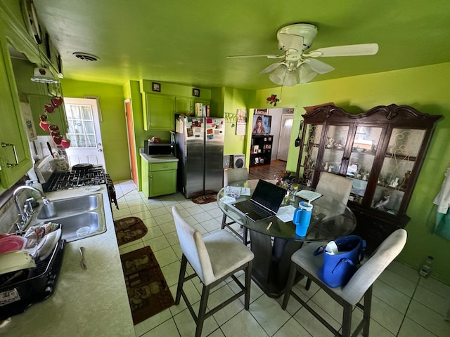 dining room featuring sink, ceiling fan, and light tile patterned floors