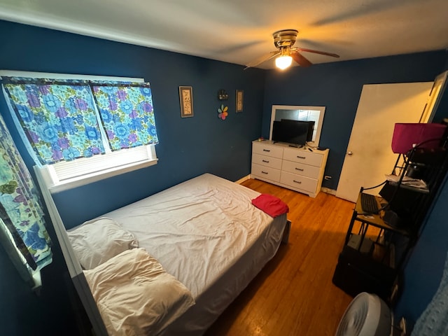 bedroom with ceiling fan and wood-type flooring