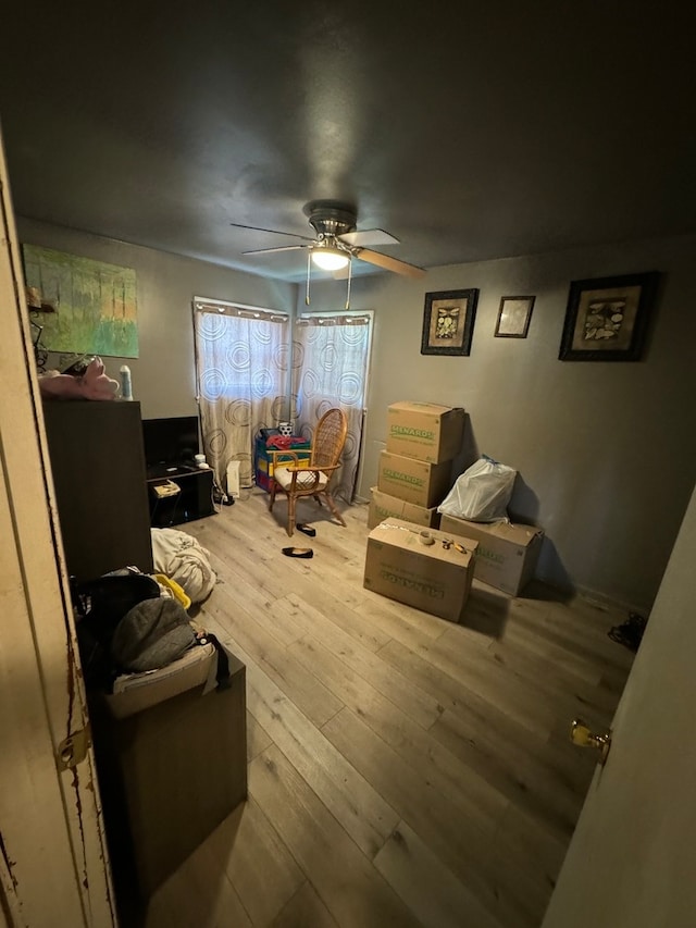 living room featuring ceiling fan and light wood-type flooring