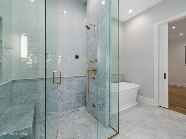 bathroom with hardwood / wood-style floors and shower with separate bathtub