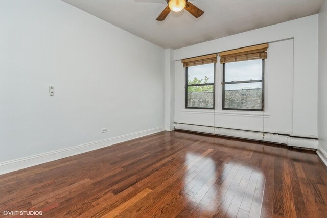 empty room with a baseboard radiator, dark wood-type flooring, and ceiling fan