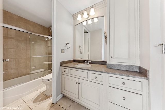 full bath featuring tile patterned flooring, enclosed tub / shower combo, toilet, and vanity