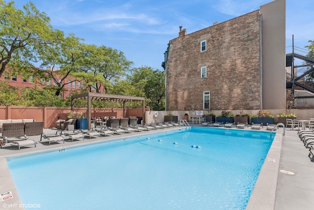 pool featuring an outdoor living space, a pergola, a patio, and fence