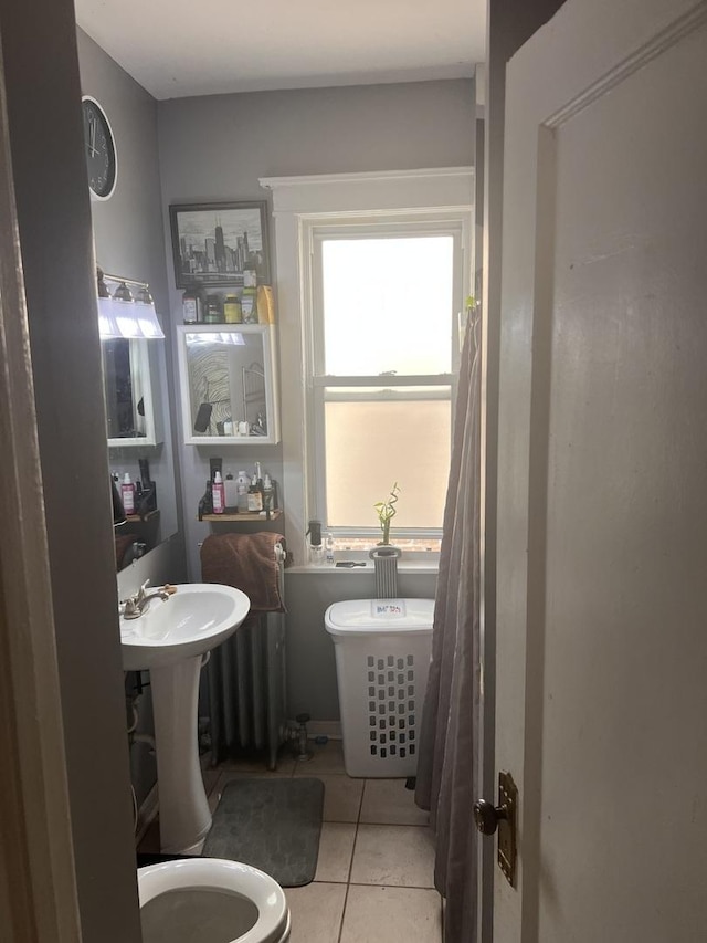 bathroom featuring tile patterned flooring and toilet