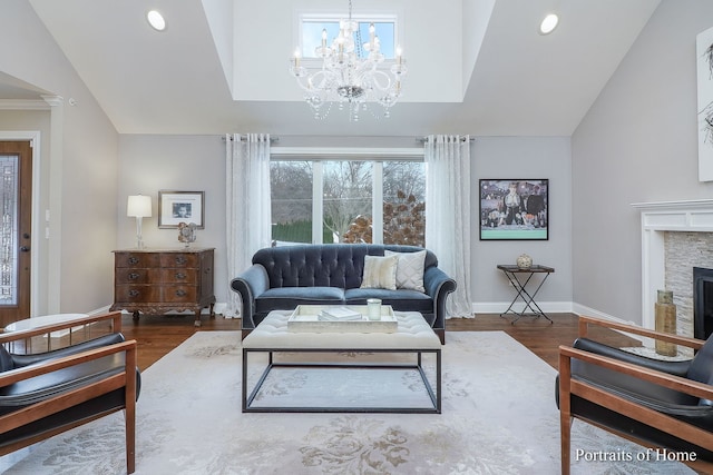 living room with lofted ceiling, a stone fireplace, and dark hardwood / wood-style floors