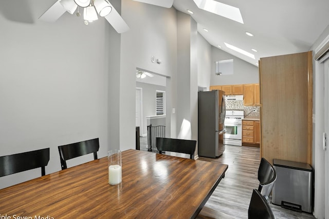 28629 W Ravine Dr, Barrington, IL 60010 - unfurnished dining area featuring ceiling fan, a skylight, high vaulted ceiling, recessed lighting, and wood finished floors