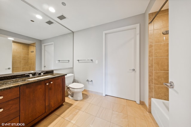 full bathroom featuring tiled shower / bath, vanity, toilet, and tile patterned floors