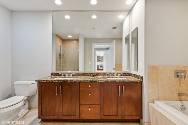 full bathroom featuring independent shower and bath, toilet, and vanity