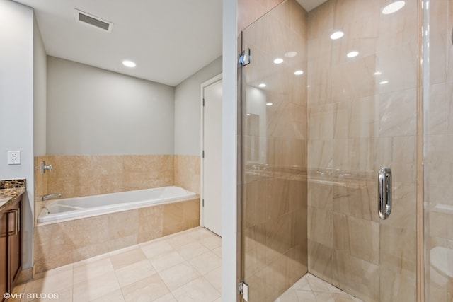 bathroom featuring tile patterned flooring, separate shower and tub, and vanity