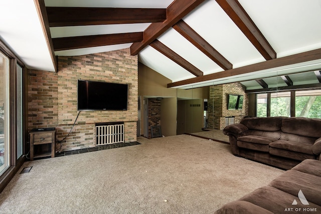 living room with carpet flooring, brick wall, high vaulted ceiling, beam ceiling, and a fireplace