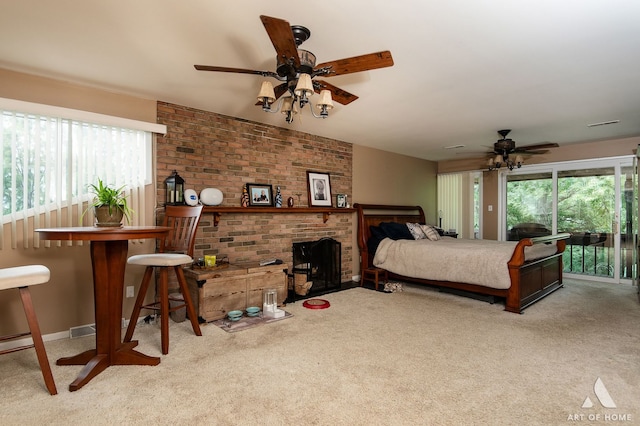 carpeted bedroom with ceiling fan, brick wall, and access to exterior