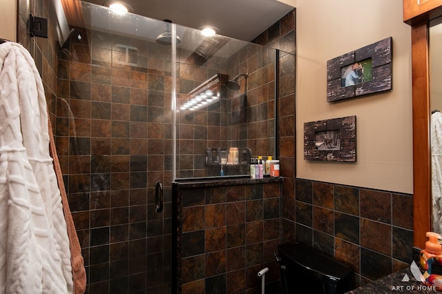 bathroom with toilet and an enclosed shower