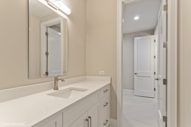 bathroom with tile patterned flooring and vanity