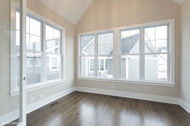 unfurnished sunroom featuring vaulted ceiling