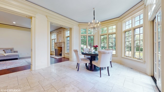 dining space with crown molding and an inviting chandelier