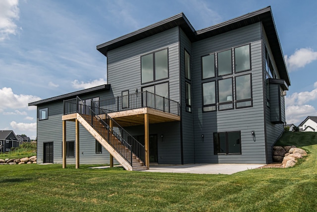 back of house with a patio, a deck, and a lawn