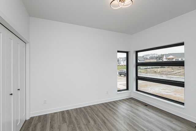 unfurnished bedroom with hardwood / wood-style flooring and a closet