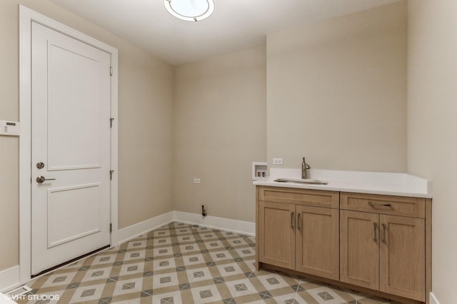 laundry area featuring washer hookup, sink, and cabinets