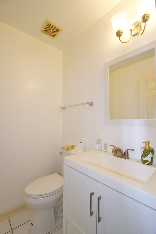 bathroom featuring vanity, tile patterned floors, and toilet