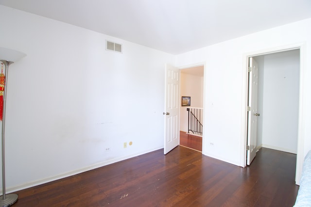 spare room with dark hardwood / wood-style floors