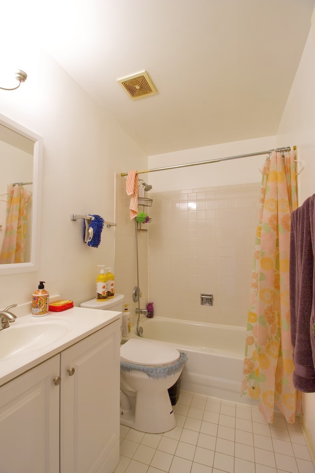 full bathroom with shower / tub combo with curtain, vanity, toilet, and tile patterned floors